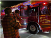 Family standing in front of decorated fire truck