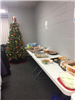 A table full of food and a Christmas tree