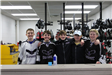 Teens posing with hockey gear