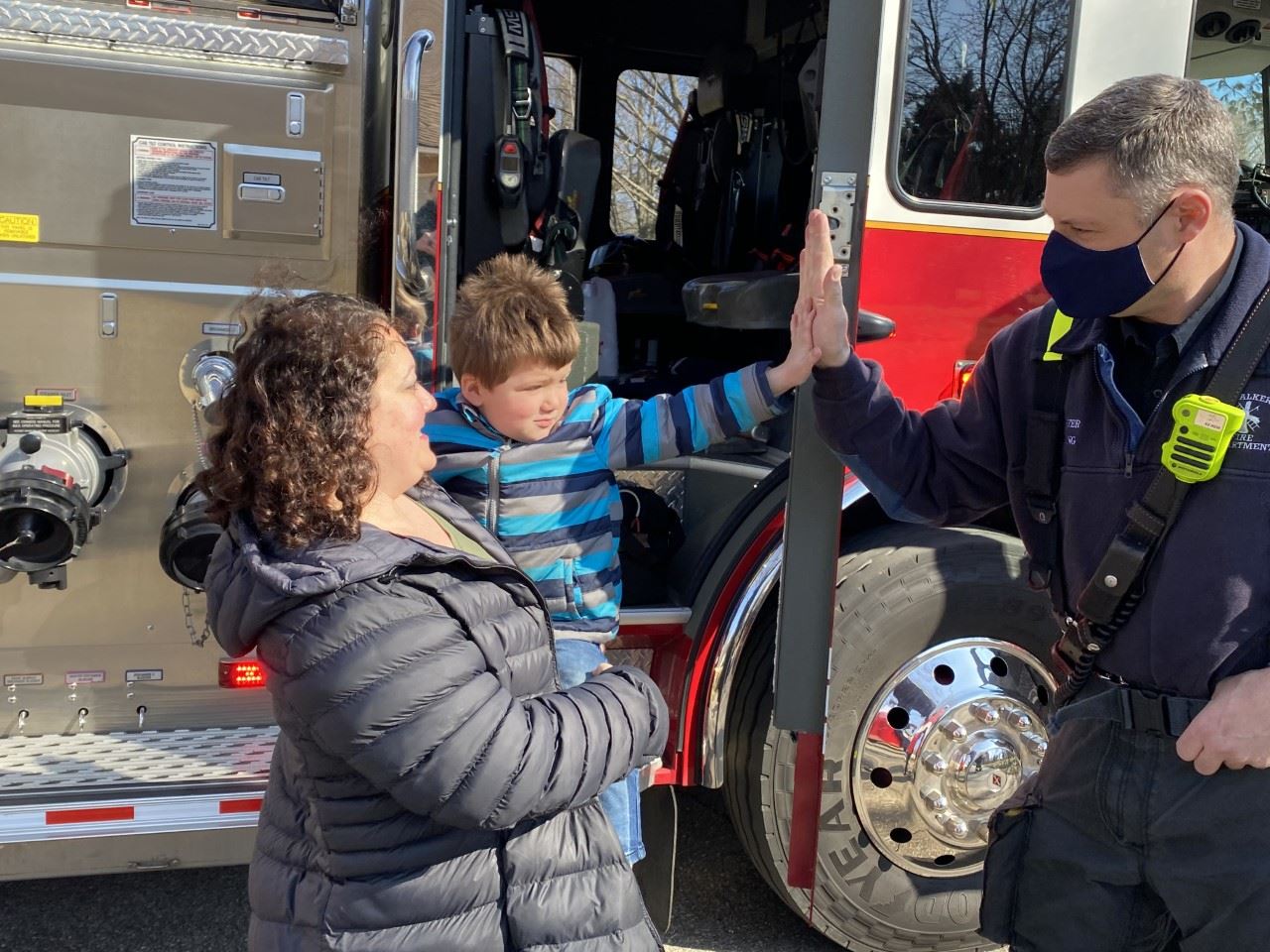 Firefighter gives toddler a high five