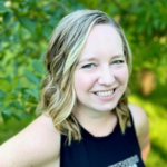Woman standing in front of flowers