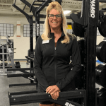 woman standing in front of fitness equipment