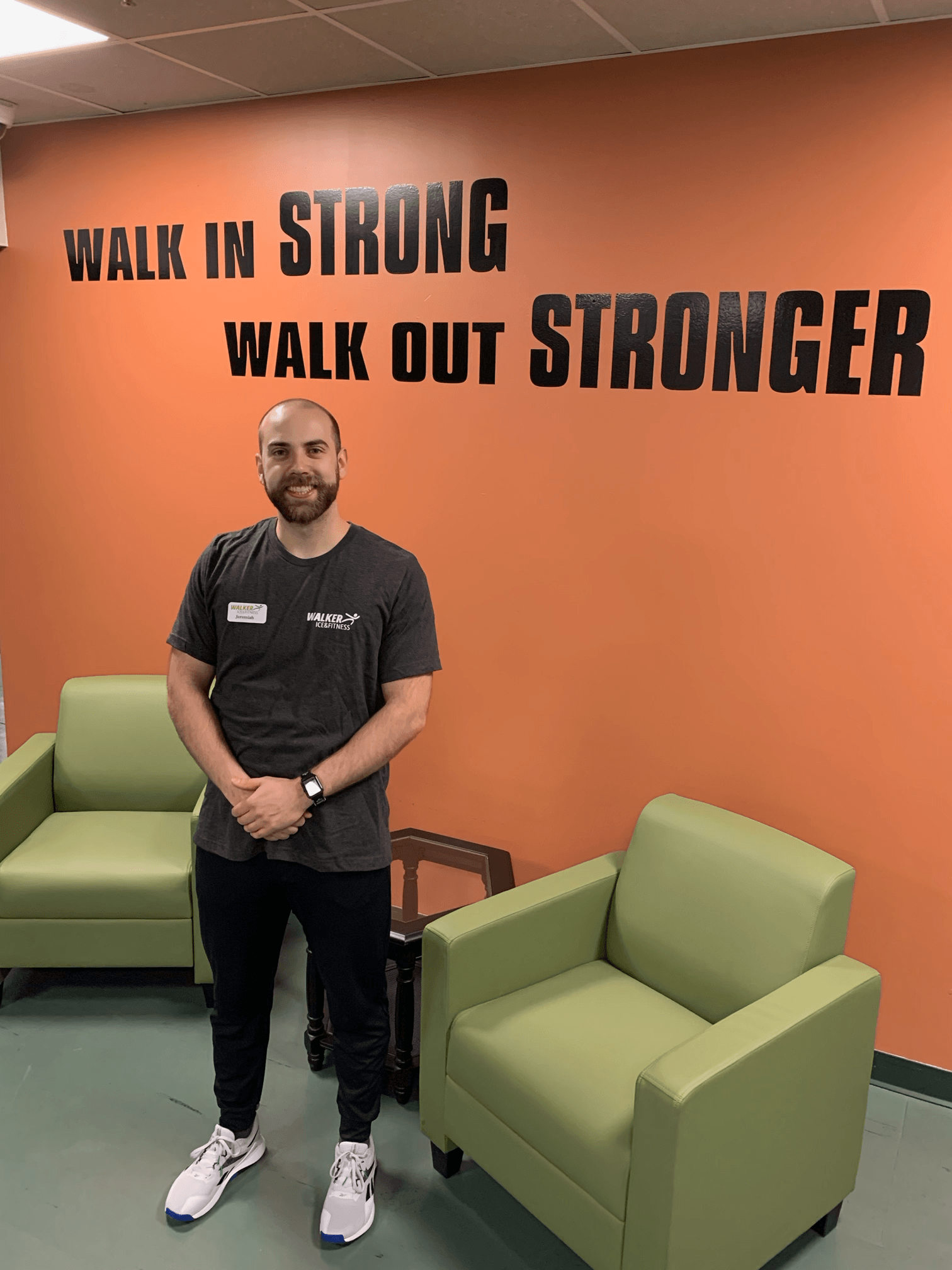 man standing in front of an orange wall