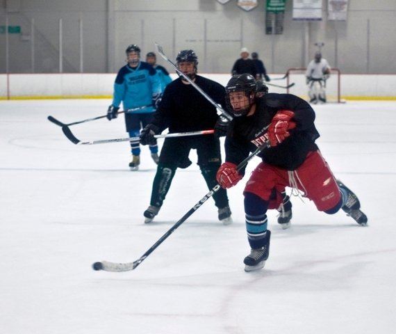 Adults playing hockey