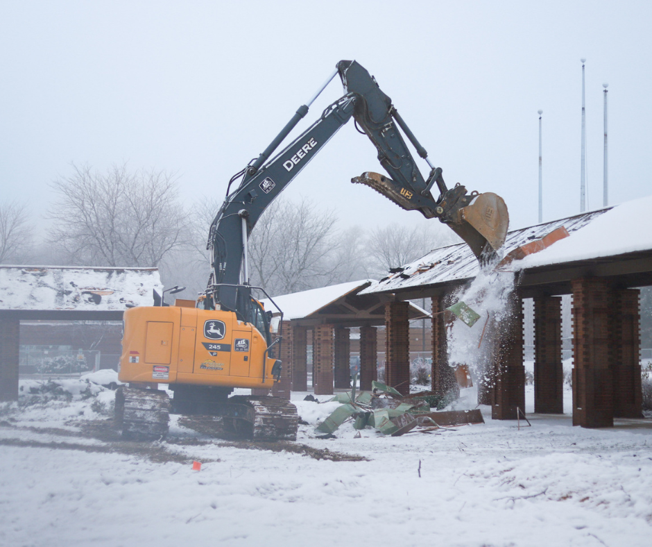 Bulldozer taking roof off overhead walkway