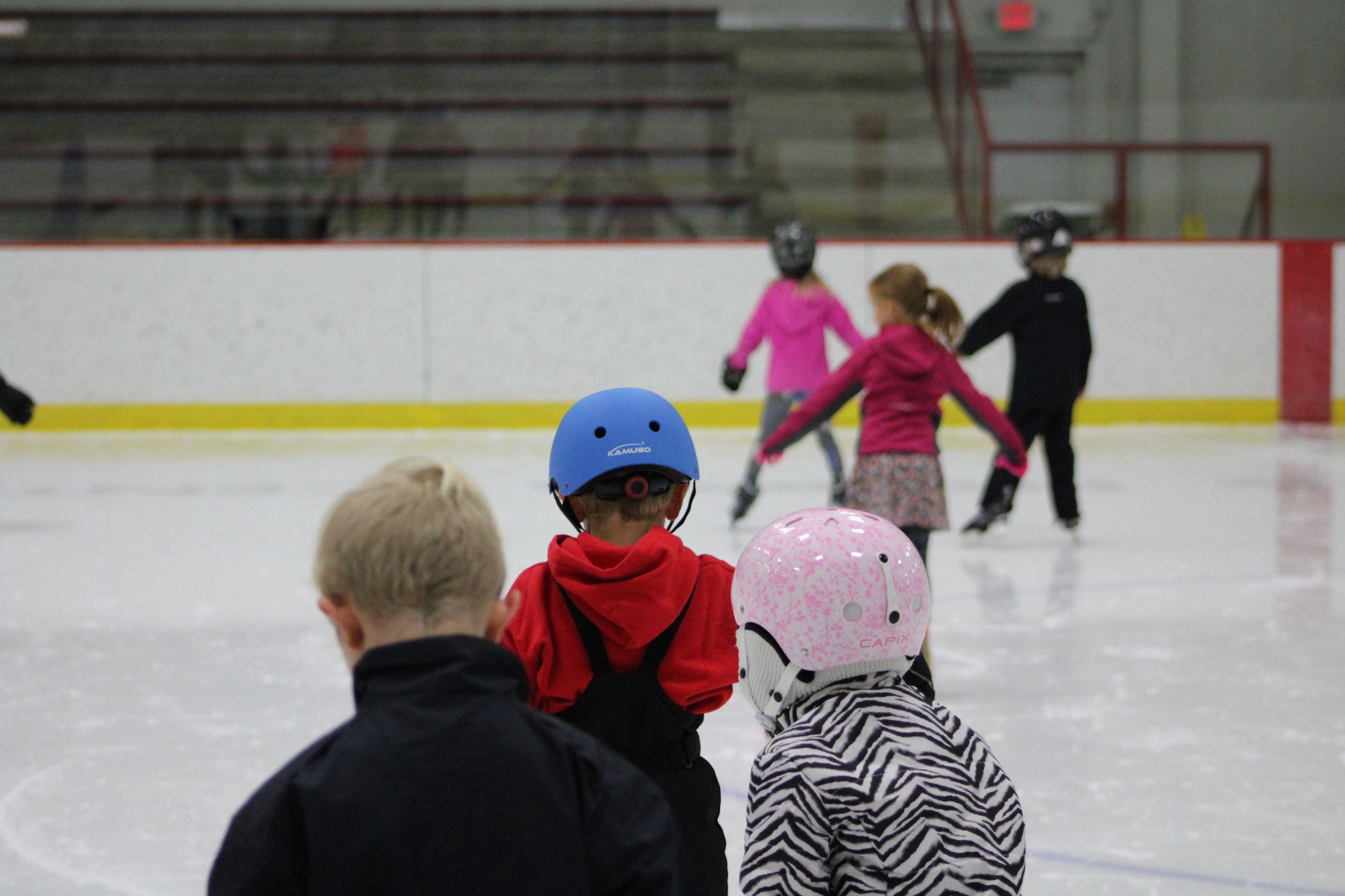 Learn to Skate participants show off their helmets
