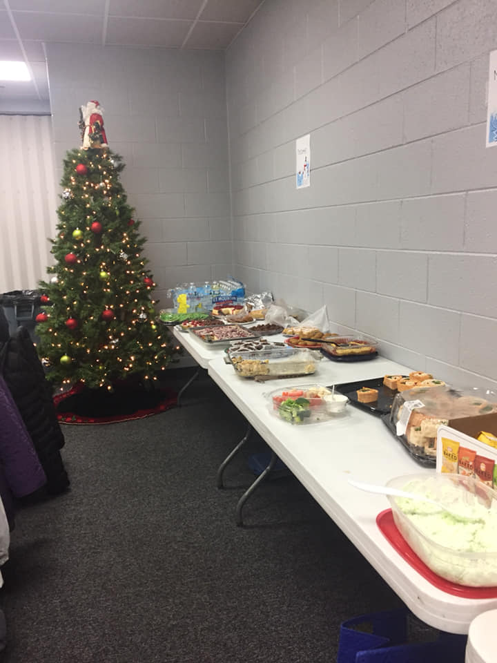 A table full of food and a Christmas tree