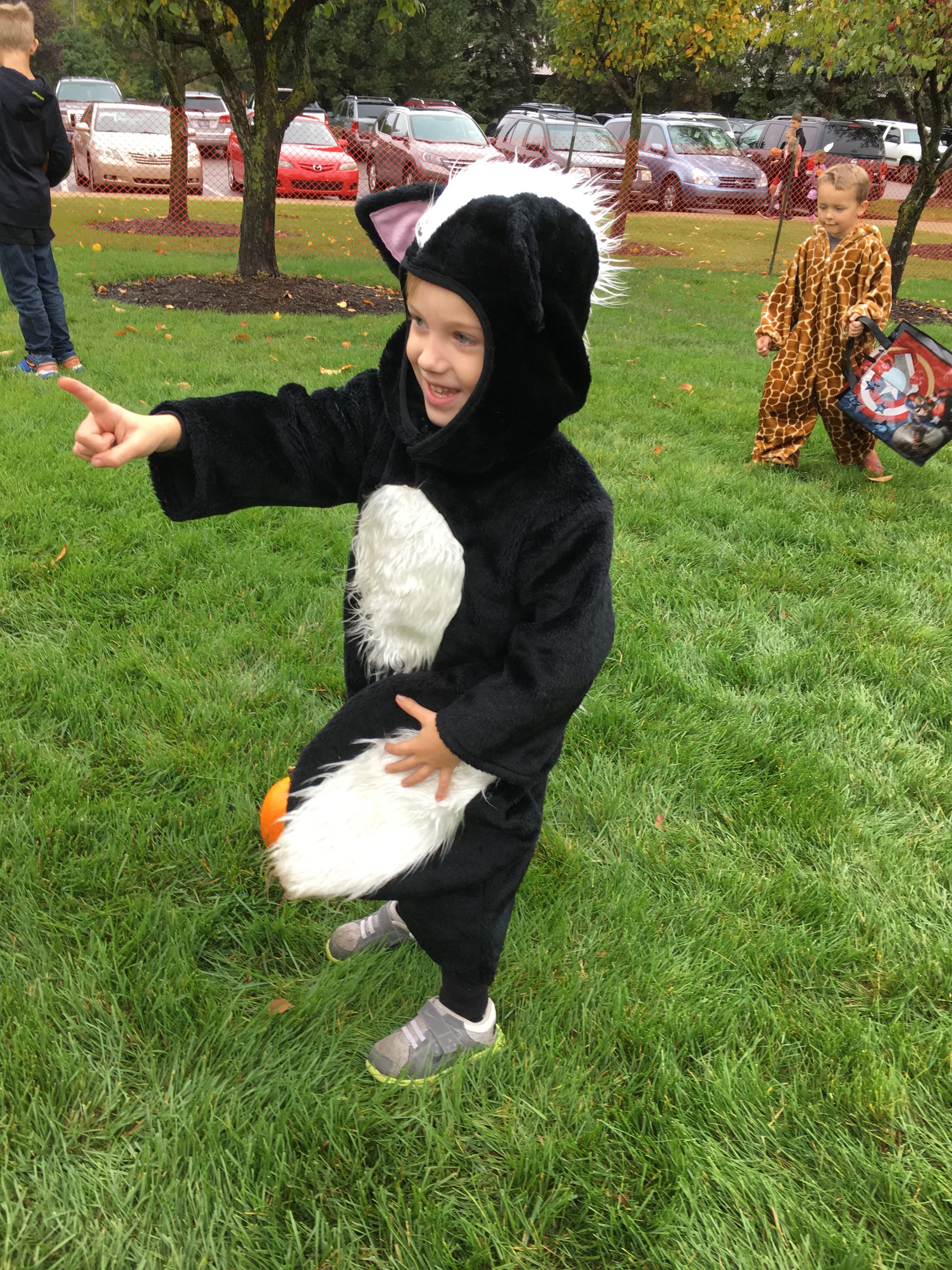 A child in a skunk costume